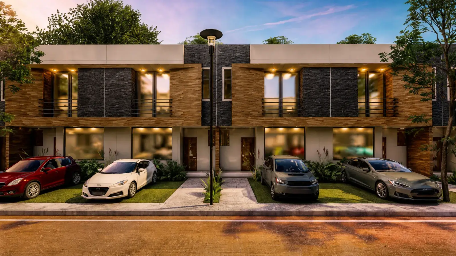 Fachada de las casas de Garden View al atardecer, con parqueo frontal